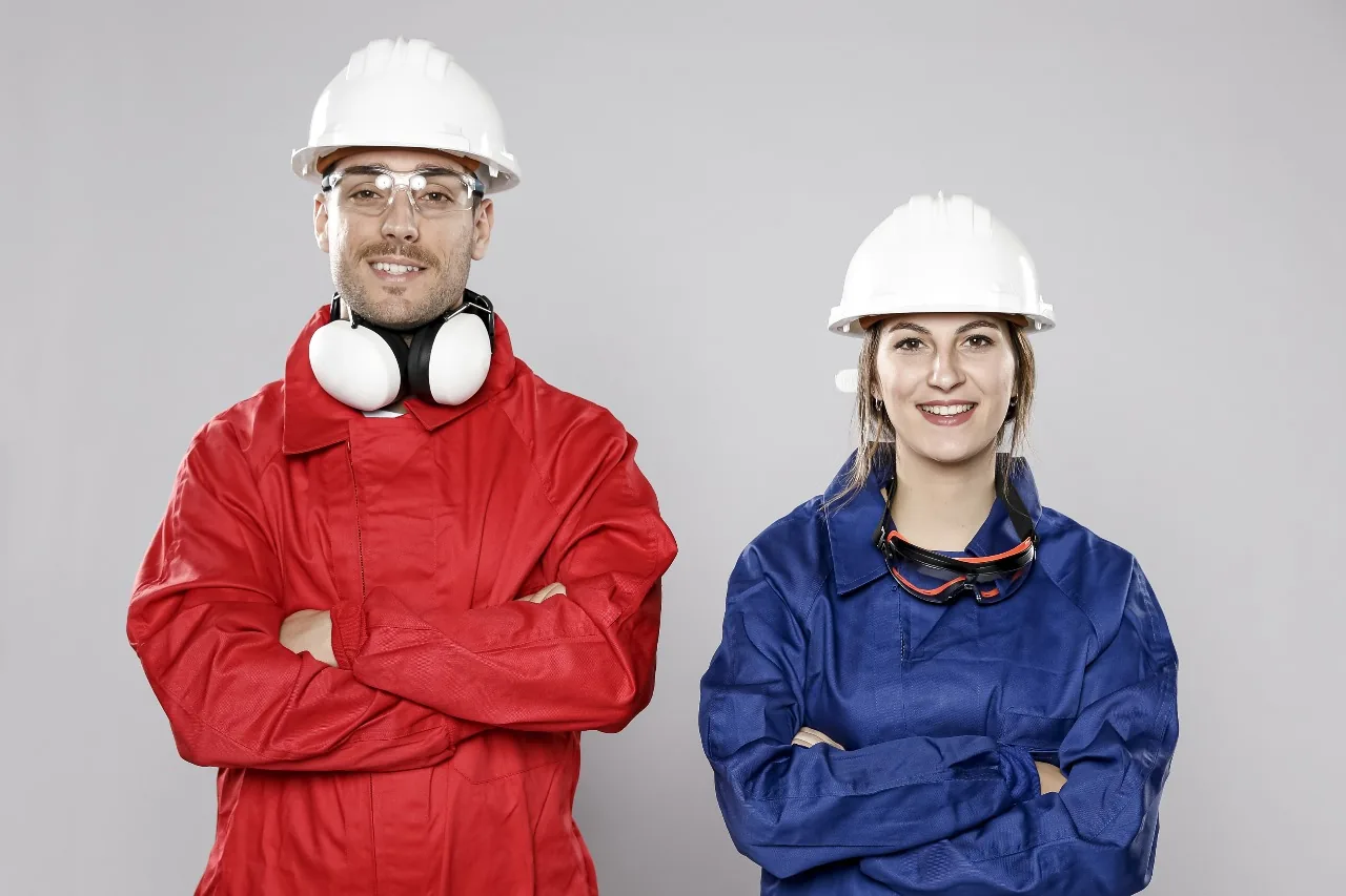 Industrial workers wearing red and blue work uniforms
