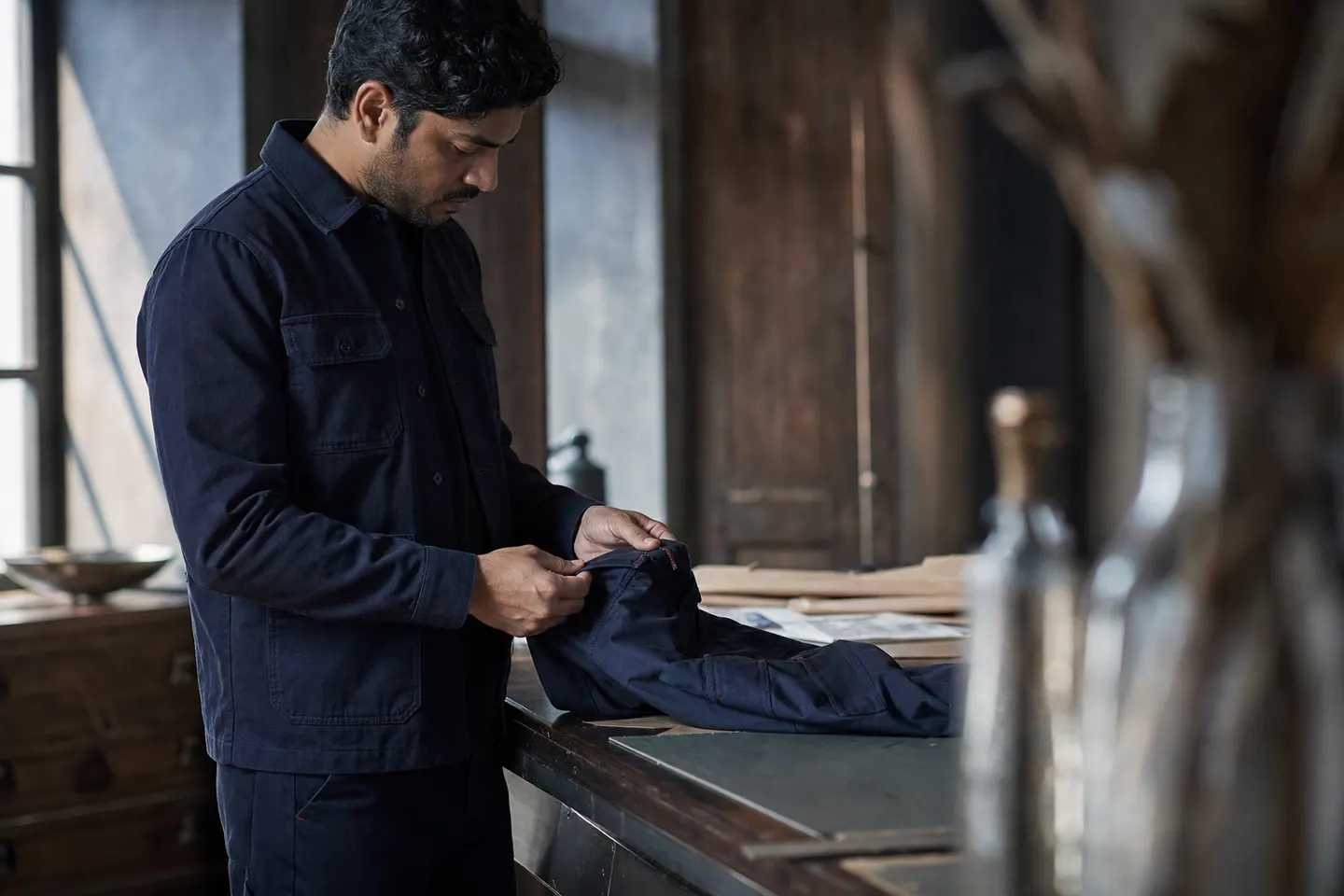 A specialist inspecting a navy industrial garment