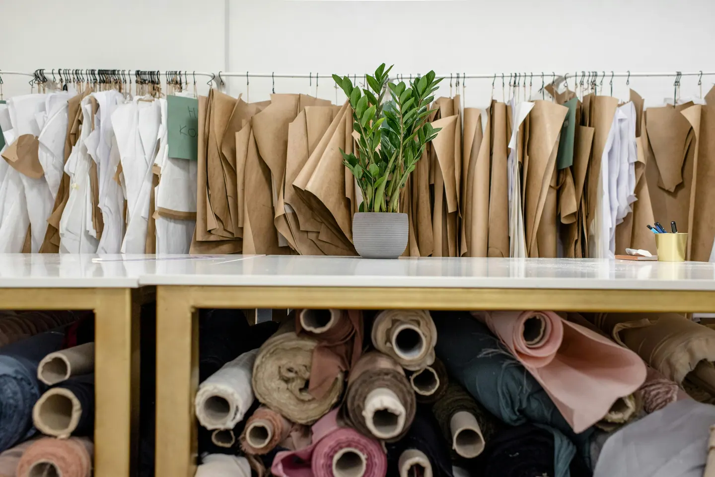 A tailor working carefully with fabric in an atelier