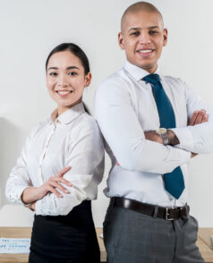 smiling-portrait-young-businessman-businesswoman-standing-back-back-office smiling-portrait-young-businessman-businesswoman-standing-back-back-office
